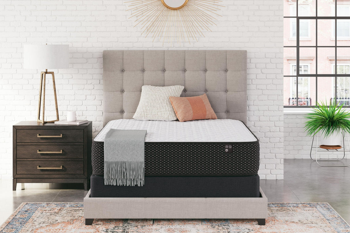 Limited Edition Firm innerspring mattress on beige bed frame in modern bedroom with white brick wall