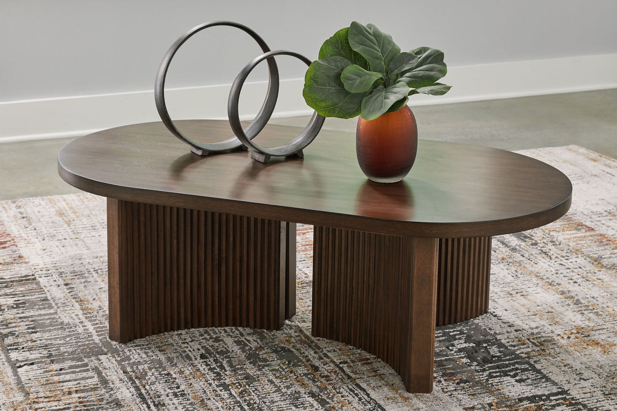 Korestone - Dark Brown - Oval Cocktail Table by Signature Design by Ashley® | Bel Furniture