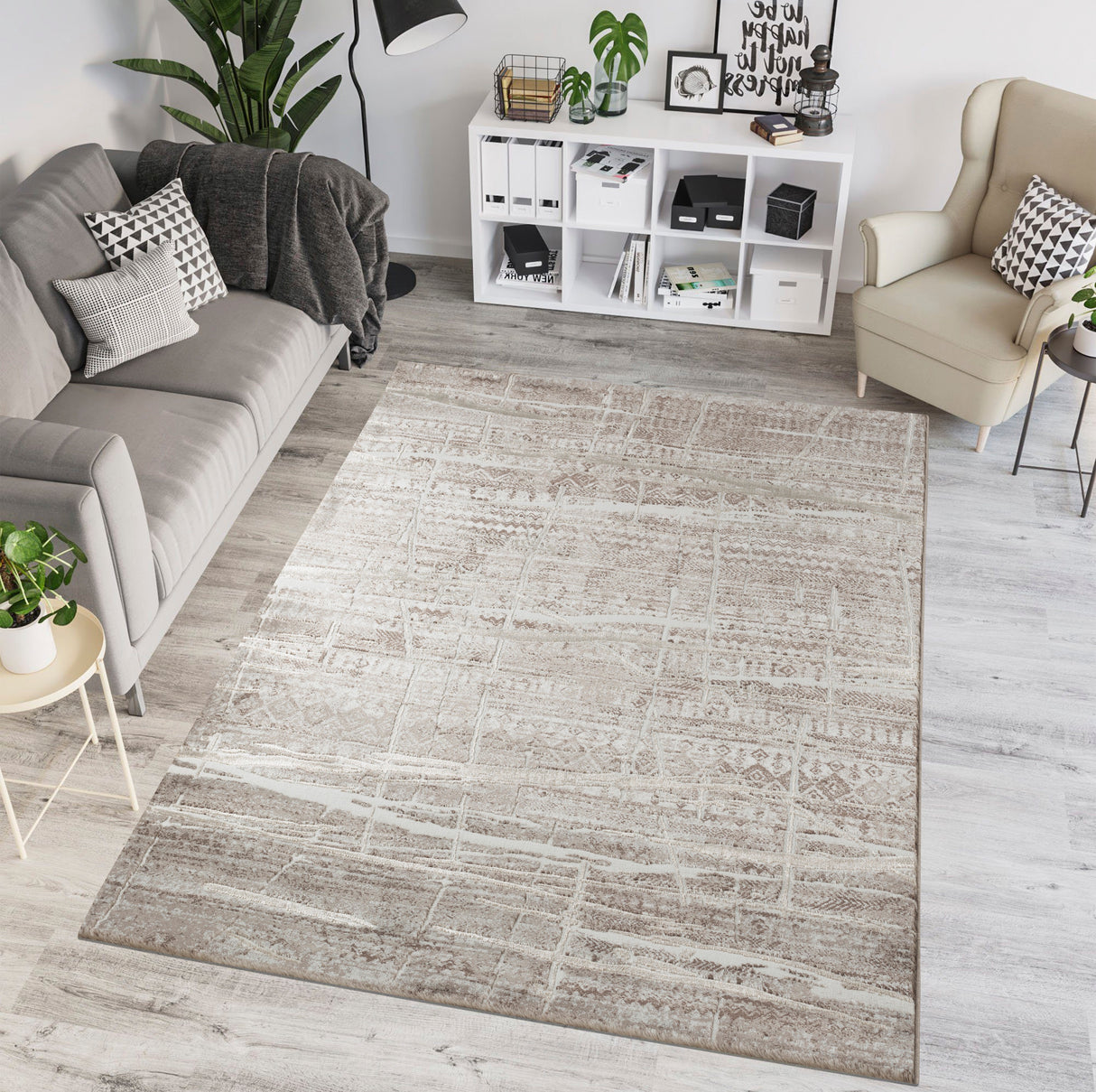 Living room with a gray area rug, sofa, and armchair.