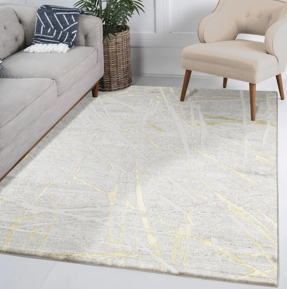 Living room with a gray rug featuring yellow lines, a gray sofa, and a beige armchair.