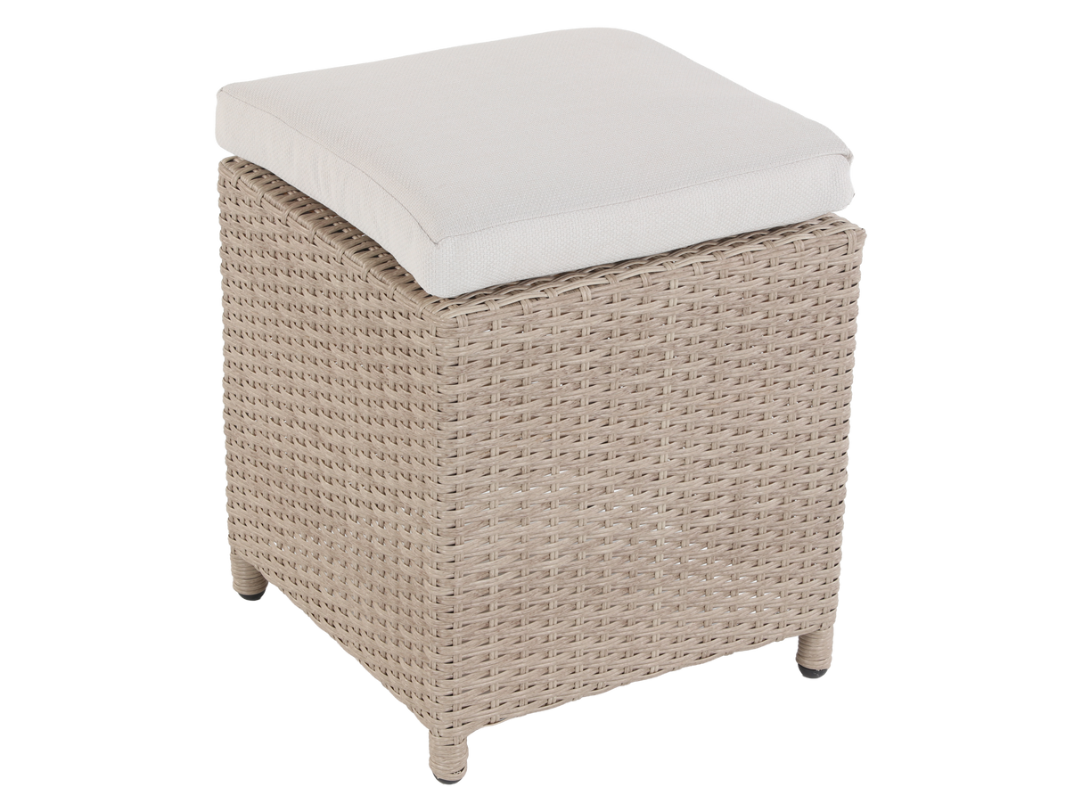 Wicker ottoman with a white cushion on a white background