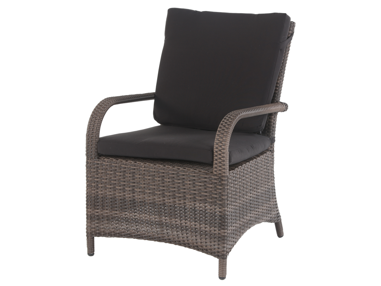Wicker chair with black cushions on a white background