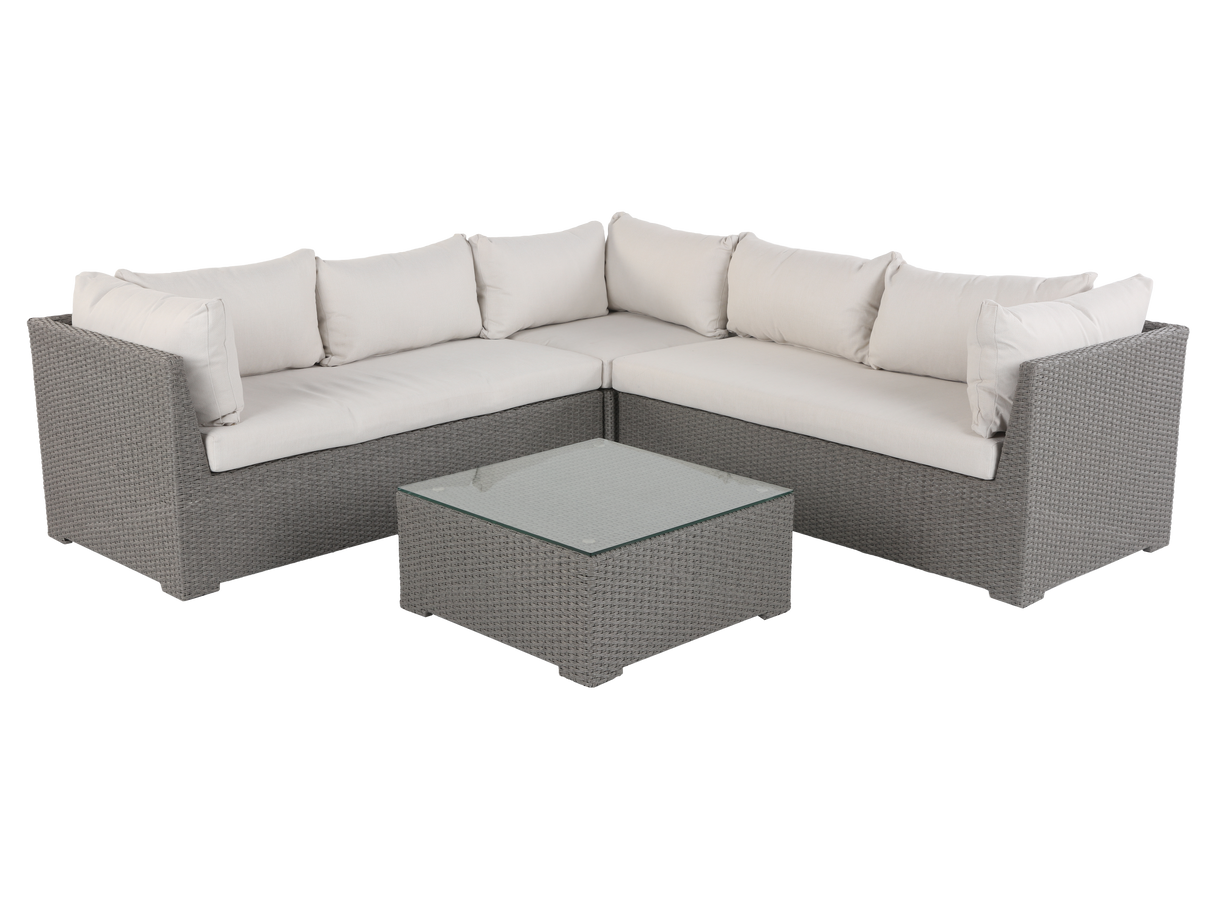 Sectional outdoor sofa with cushions and a coffee table on a white background