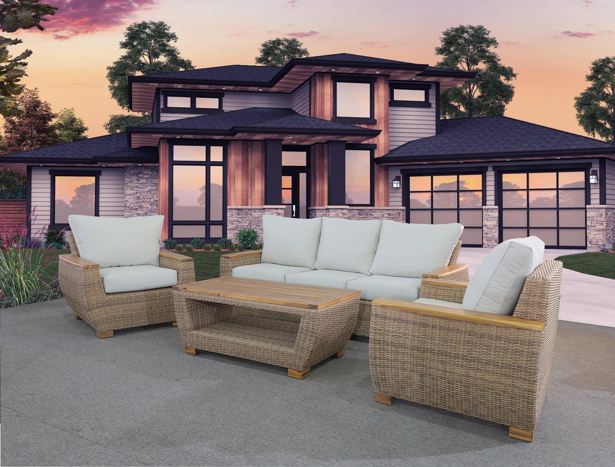 Outdoor patio furniture set with cushions in front of a house during sunset.