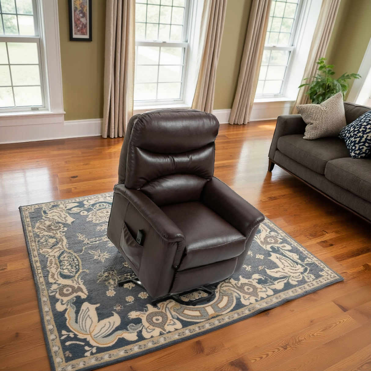 Brown leather recliner chair on a decorative rug in a living room setting.