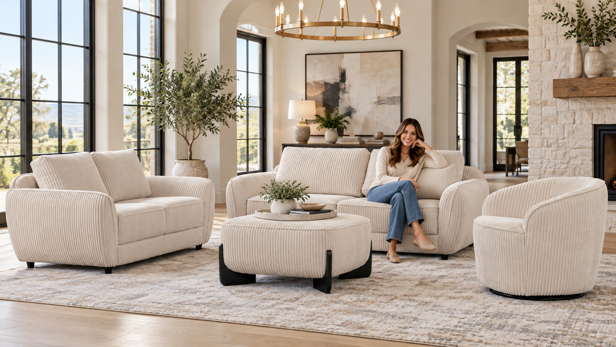 Woman seated on Bel Furniture's beige corduroy four-piece living room set in a sunlit contemporary room