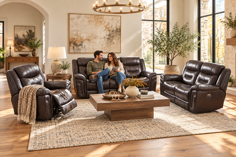 Couple relaxing on a chocolate-brown leather living room set in an autumn-inspired room