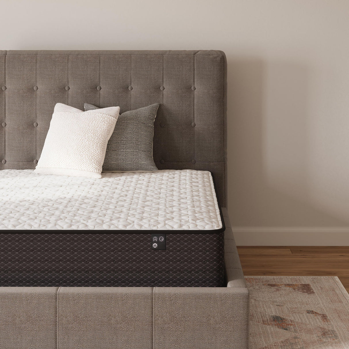 Sierra Sleep Limited Edition Firm innerspring mattress on gray upholstered bed with pillows - Bel Furniture