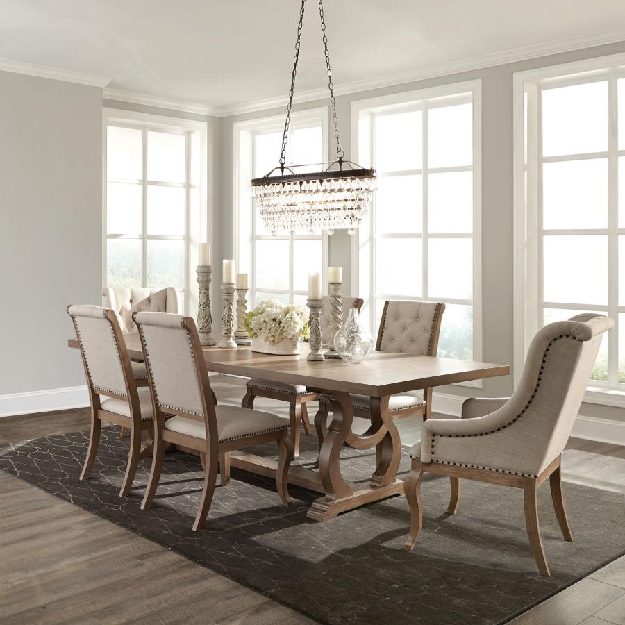 Dining room with wooden table and chairs in a well-lit room.