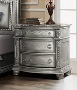 Luxurious bedroom set with silver furniture in a well-decorated room.