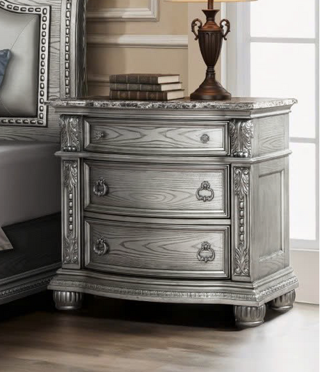 Luxurious bedroom set with silver furniture in a well-decorated room.