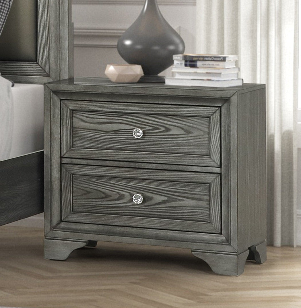 Gray bedroom furniture set with matching headboard, dressers, and nightstands in a bright room.