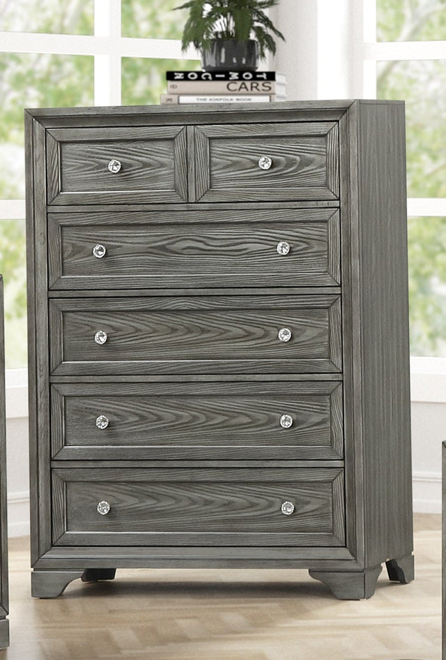 Gray bedroom furniture set with matching headboard, dressers, and nightstands in a bright room.