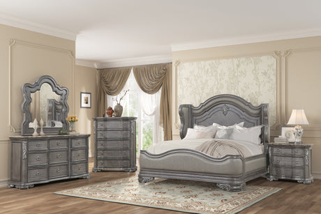 Elegant bedroom with gray upholstered bed, matching dresser, and mirror.
