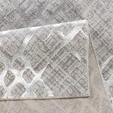 Close-up of a textured gray and white rug with geometric pattern