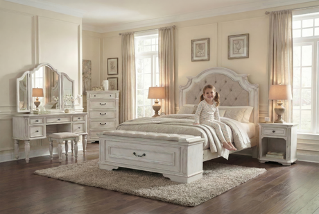 Neatly decorated bedroom with a girl on a bed, furniture, and decor.