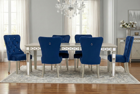Dining room with blue chairs and a silver table.