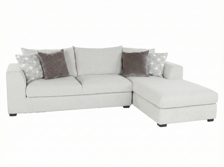 Gray sectional sofa with patterned cushions on a white background