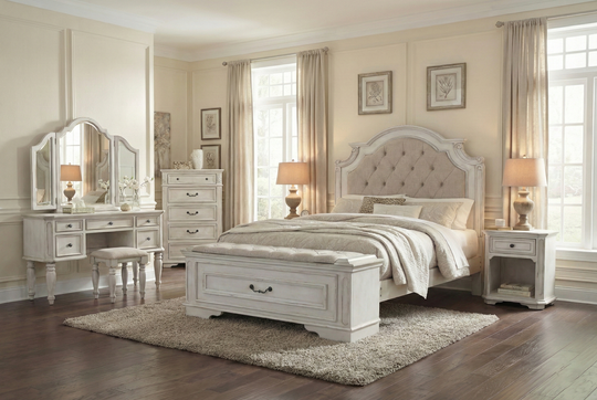Neatly arranged bedroom with a bed, dresser, and mirror.