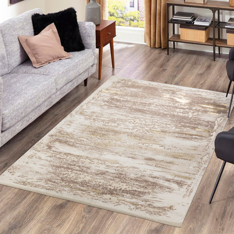 Living room with a gray sofa, patterned rug, and wooden floor.
