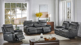 Gray reclining sofa set in a living room with large windows and decor.