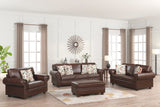 Brown leather sofa set with patterned cushions in a living room setting.
