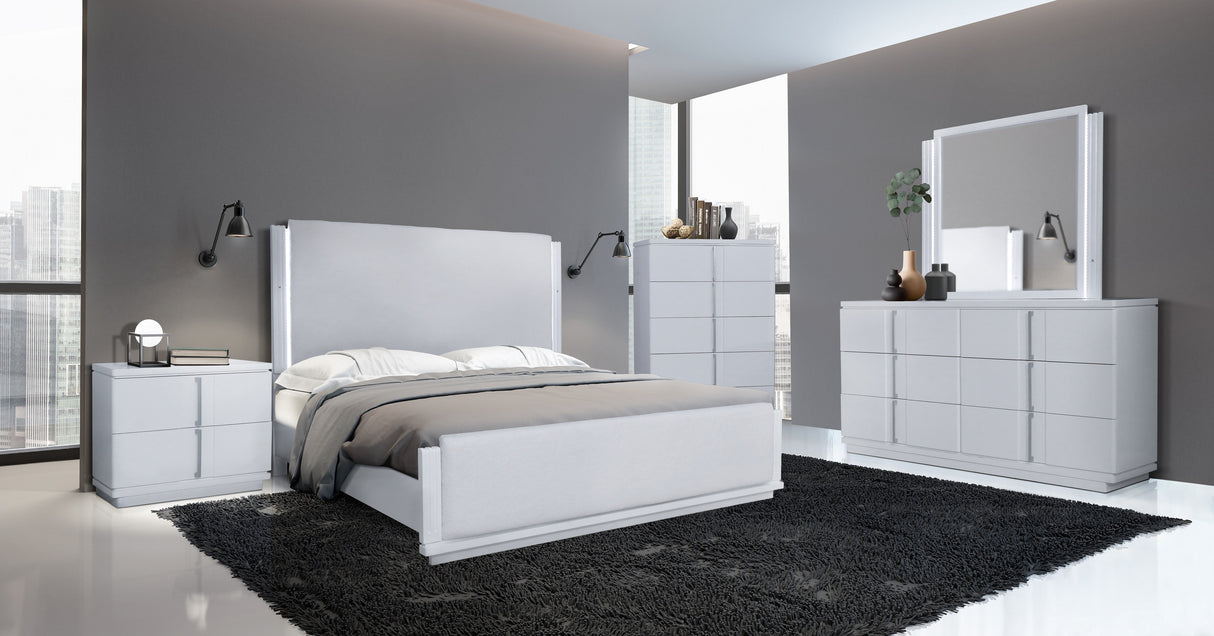 Modern bedroom with white furniture set including bed, dresser, and mirror.