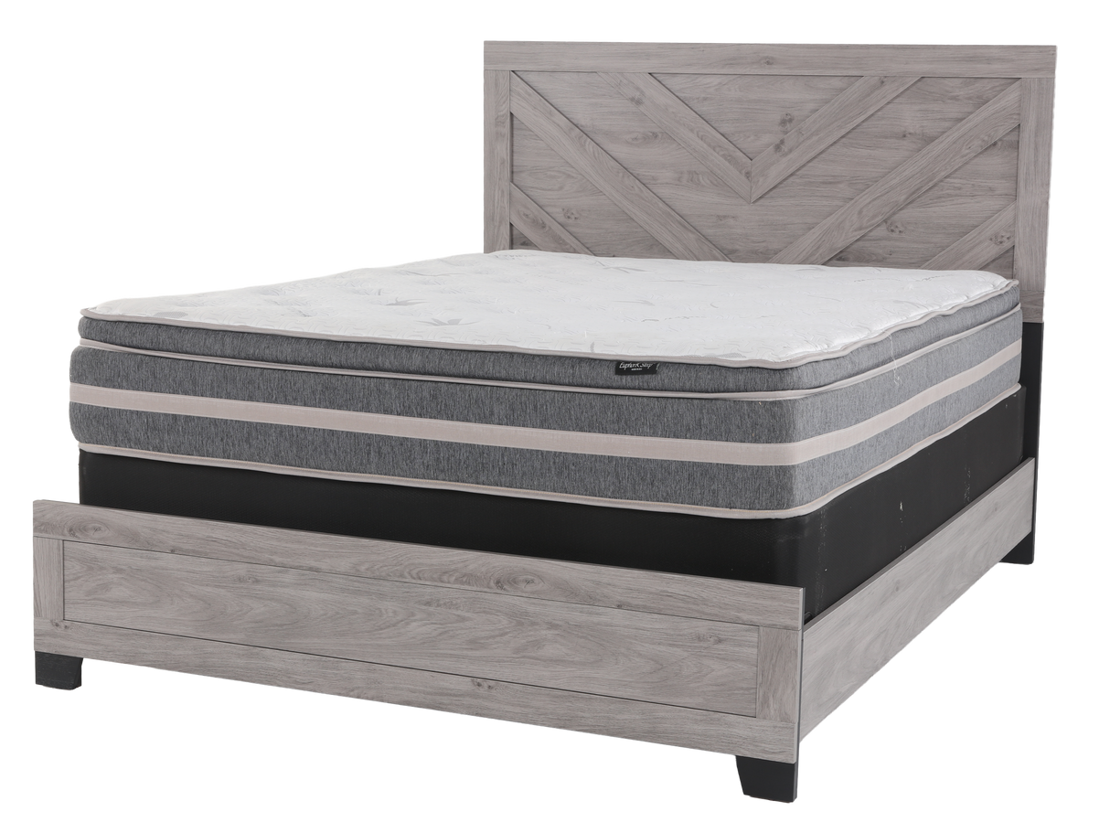 Mattress on a wooden bed frame with a white background