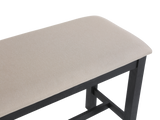 Beige cushioned bench with black metal frame on a white background
