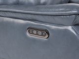 Close-up of a gray leather recliner with control panel.