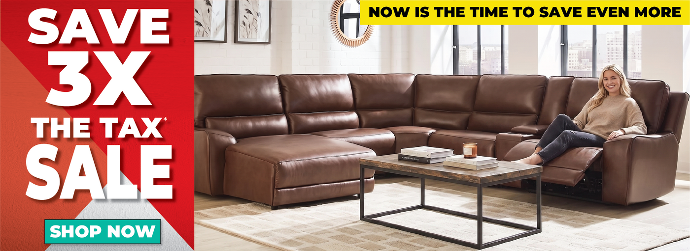 A woman reclines on a large brown leather sectional sofa in a bright living room. The sofa includes a chaise and coffee table.