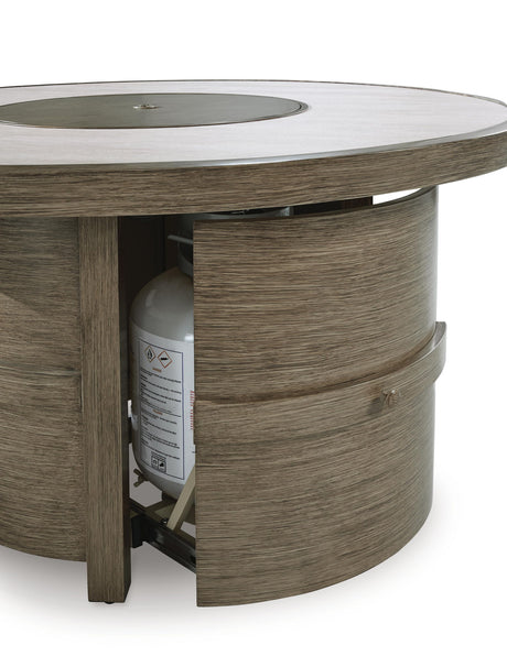 Rainier Ranch round fire pit table in beige wood grain with open door showing propane tank - Bel Furniture