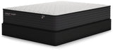 Ashley Sleep Limited Edition Firm Innerspring Mattress on black foundation, side view - Bel Furniture