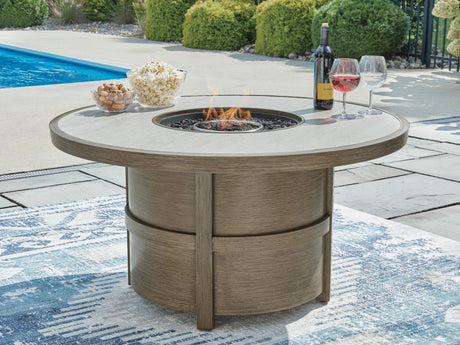 Beige round fire pit table with wood-grain finish by poolside, featuring wine and snacks - Bel Furniture
