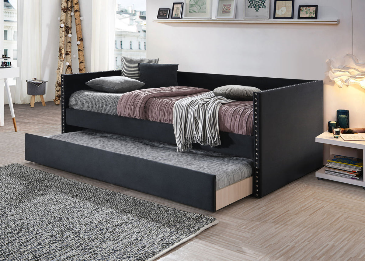 Black bed with trundle in a bedroom setting