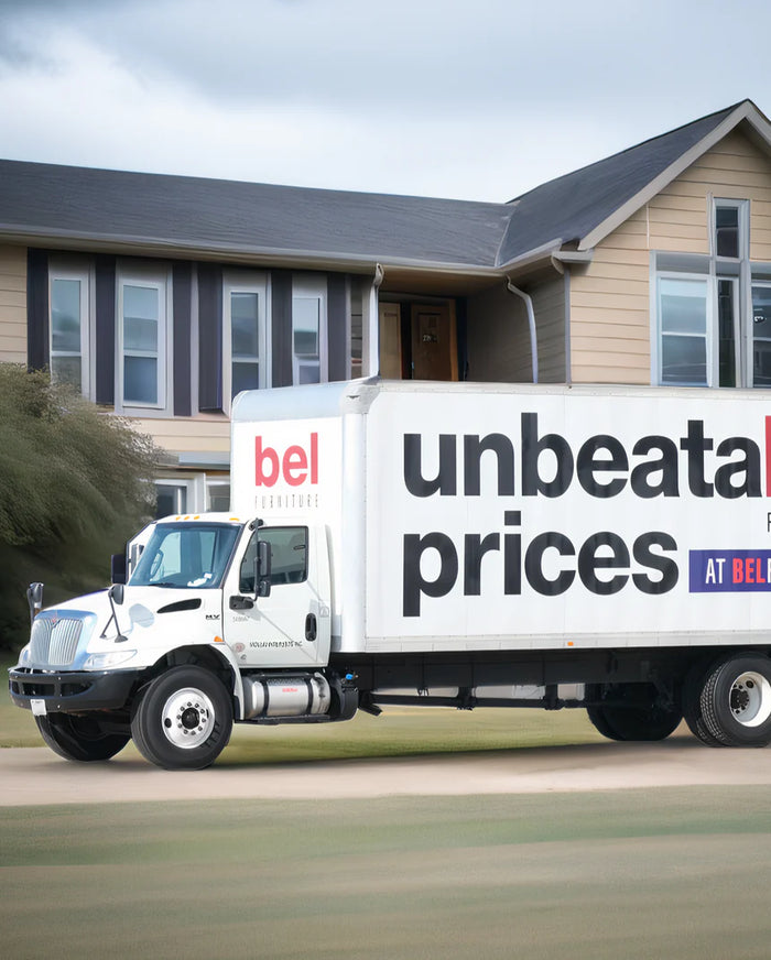 White delivery truck with 'unbeatable prices' text in front of a house